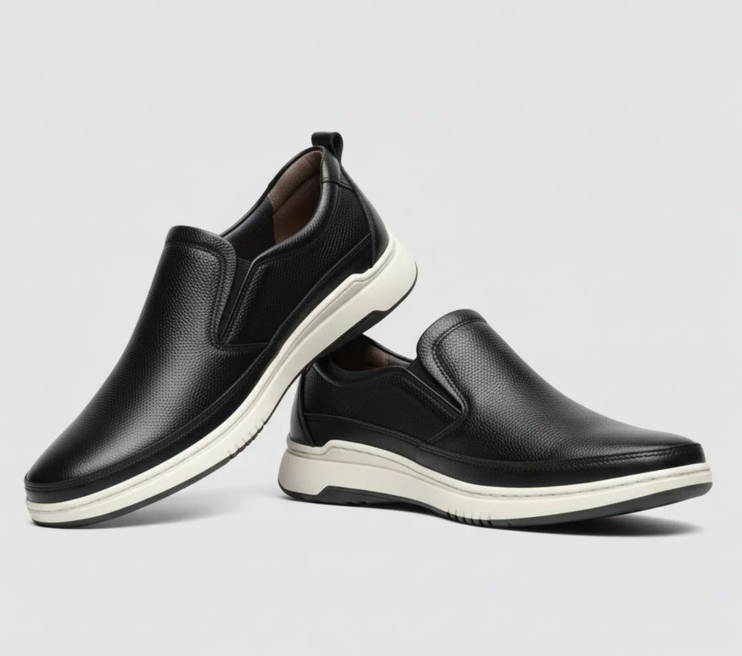 Clarks black shoes slip ins on grey background 