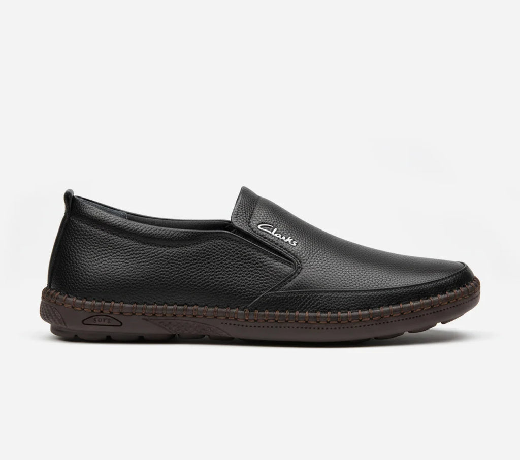 Black slip-on shoe with brand logo on a white background