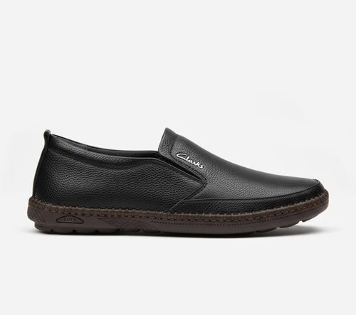 Black slip-on shoe with brand logo on a white background