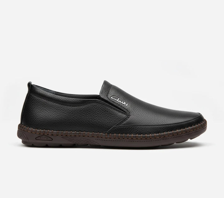 Black slip-on shoe with brand logo on a white background