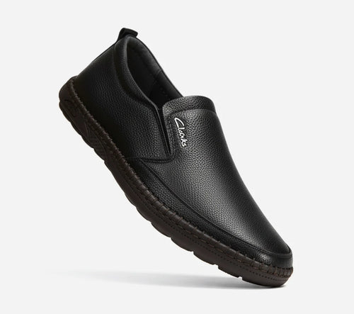 Black loafer shoe on a light gray background