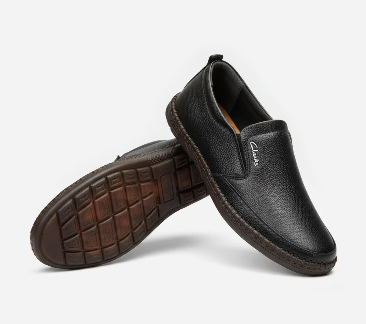 Pair of black leather shoes on a white background