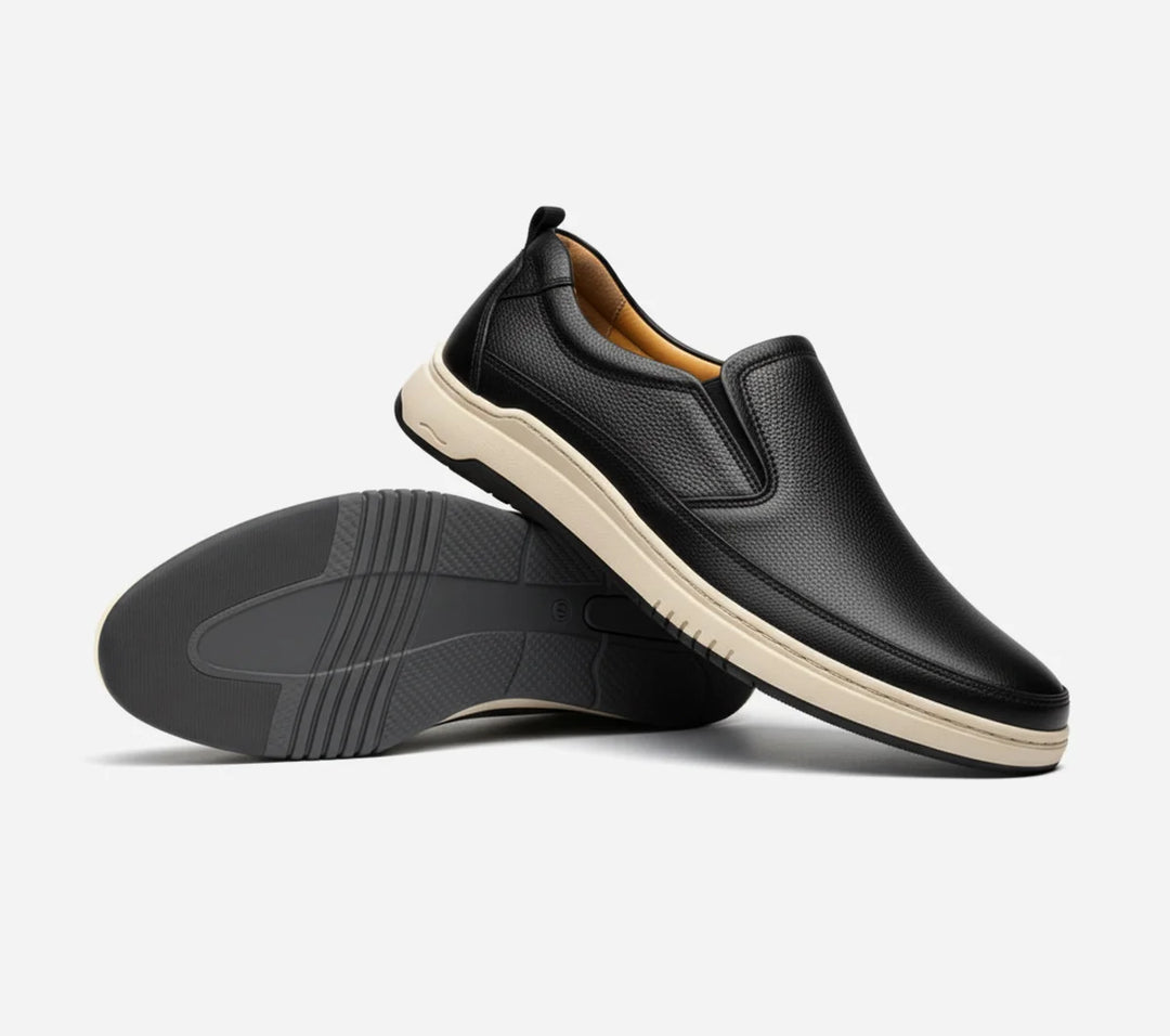 Black slip-on shoes with a white background