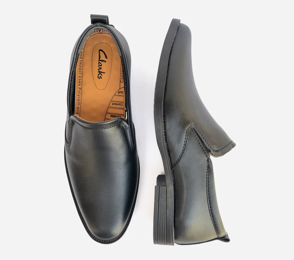Black loafer shoes with Clarks branding on a white background