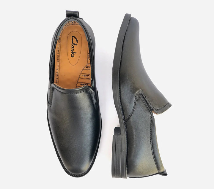 Black loafer shoes with Clarks branding on a white background