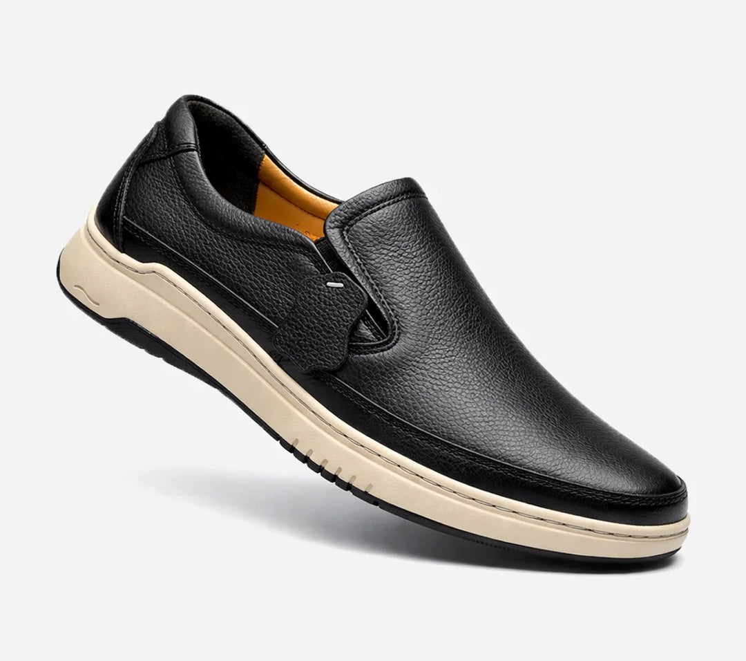 Black leather slip-on shoe on a white background