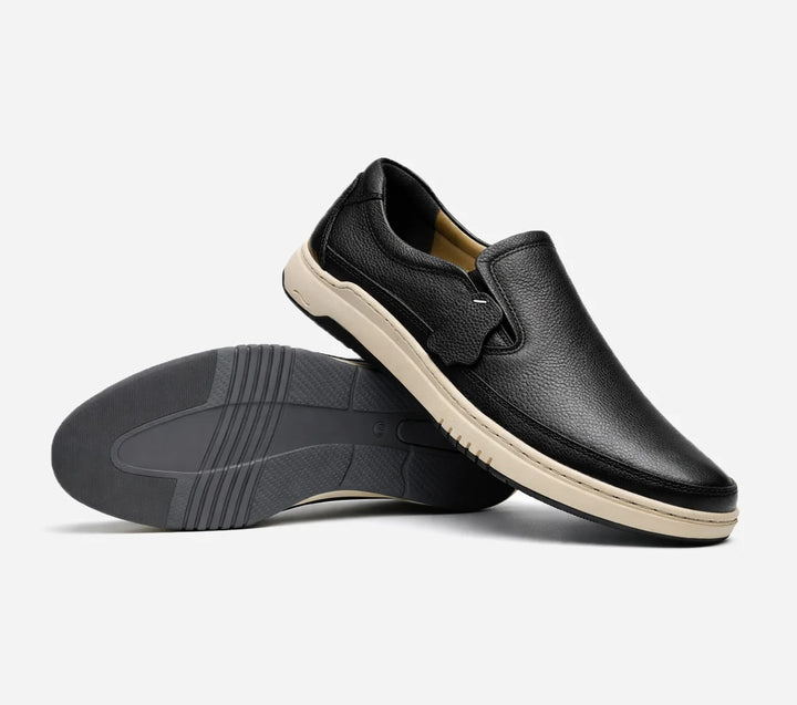 Black slip-on shoes on a light gray background