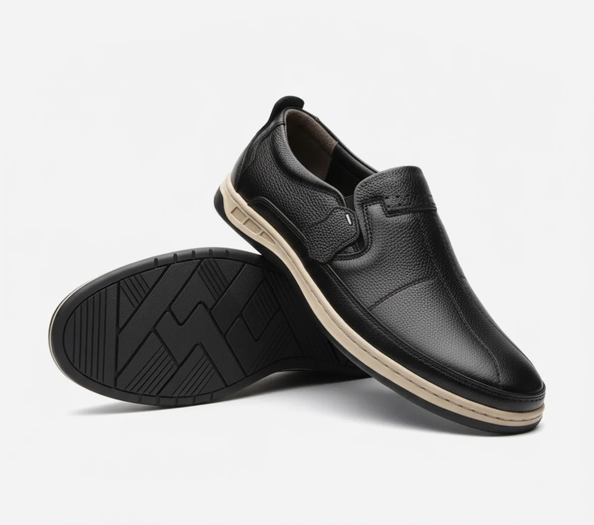 Black slip-on shoes with a white background