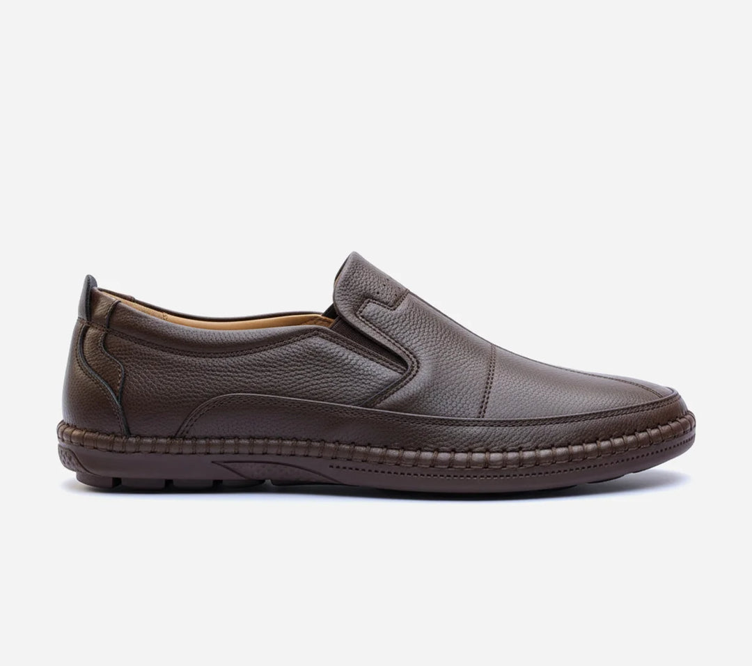 Pair of brown loafers on a light gray background
