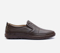 Pair of brown loafers on a light gray background