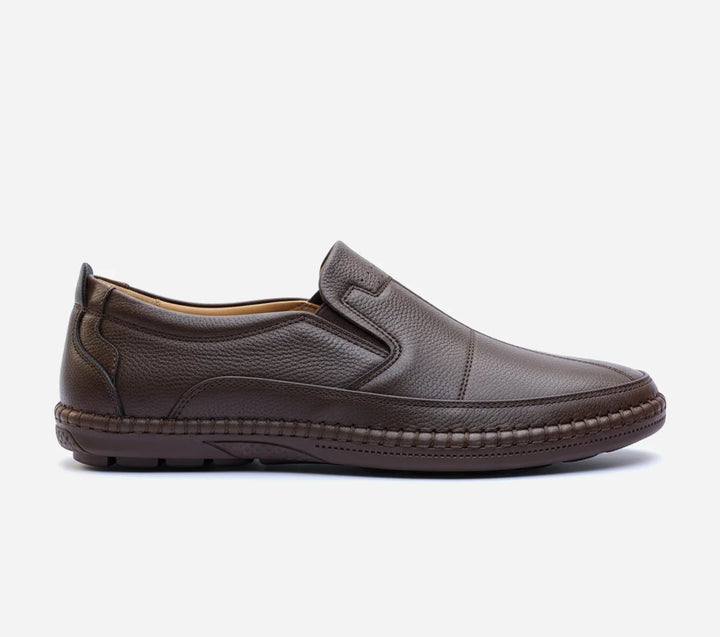 Pair of brown loafers on a light gray background