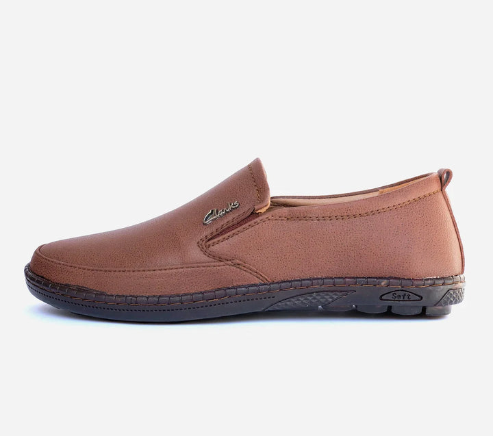 Brown slip-on shoe with black sole on a white background