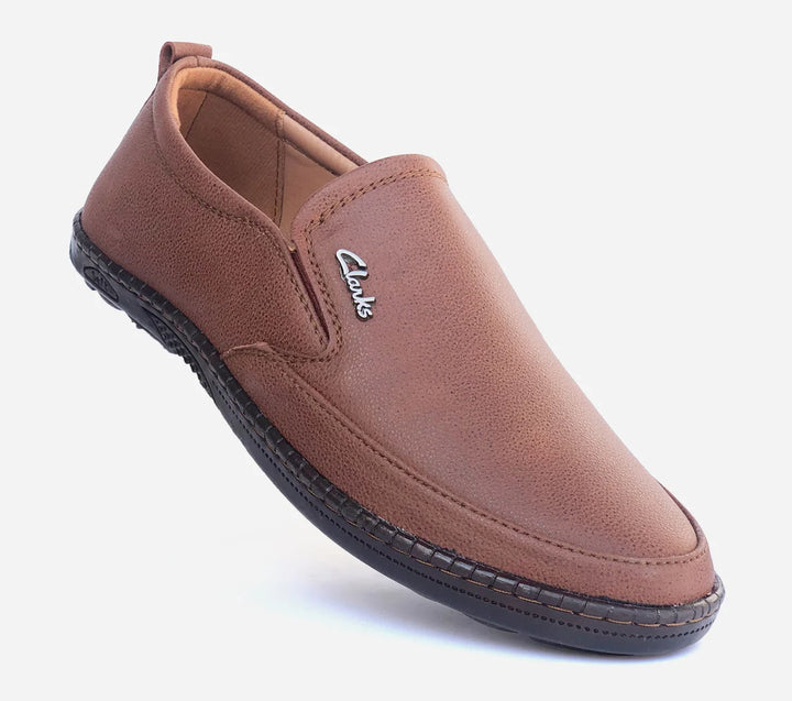 Brown slip-on shoe with Clarks logo on a white background