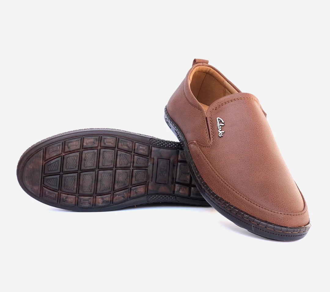 Brown leather slip-on shoe with visible brand logo on a white background