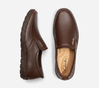 Pair of brown Clarks loafers on a white background