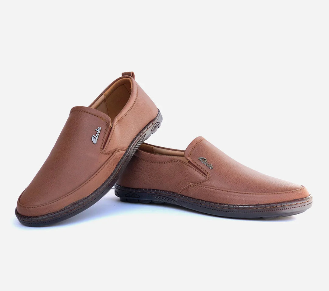 Pair of brown slip-on shoes on a light gray background