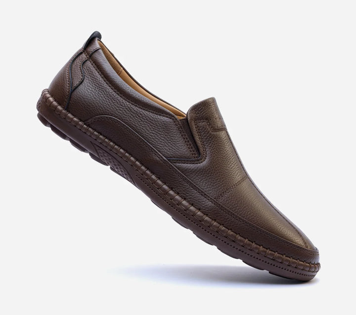 Brown leather loafer shoe on a white background
