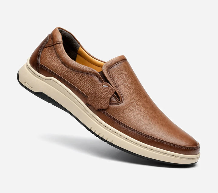 Mustard leather slip-on shoe on a white background