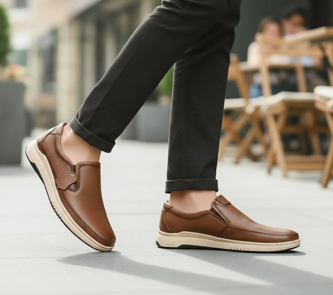 Mustard leather shoes worn with black pants on a blurred outdoor background