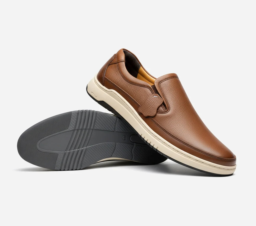 Mustard leather slip-on shoe with black sole on a white background