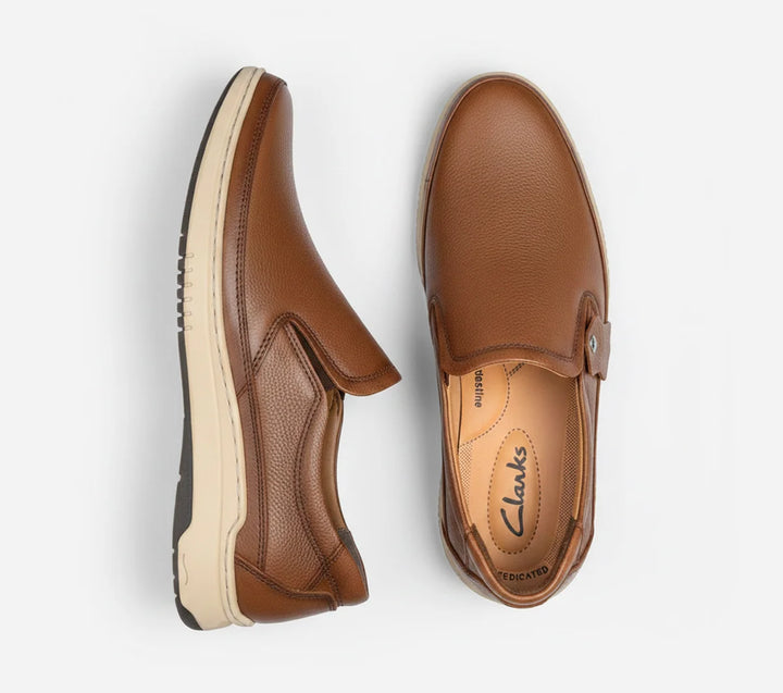 Pair of Mustard  leather shoes on a white background